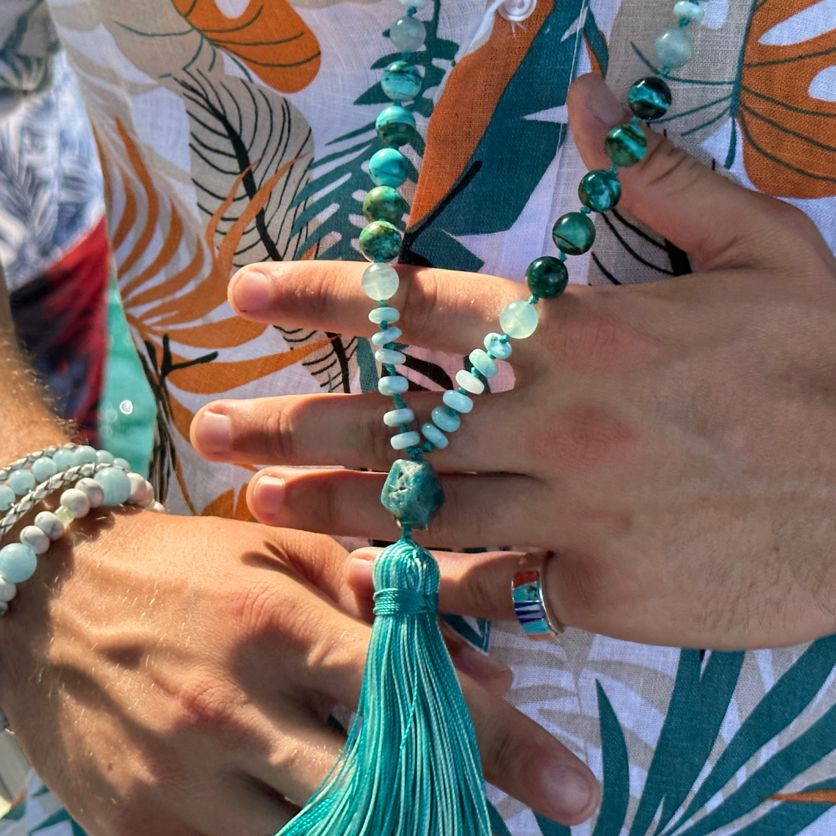 Man wearing a mala to show What is a mala
