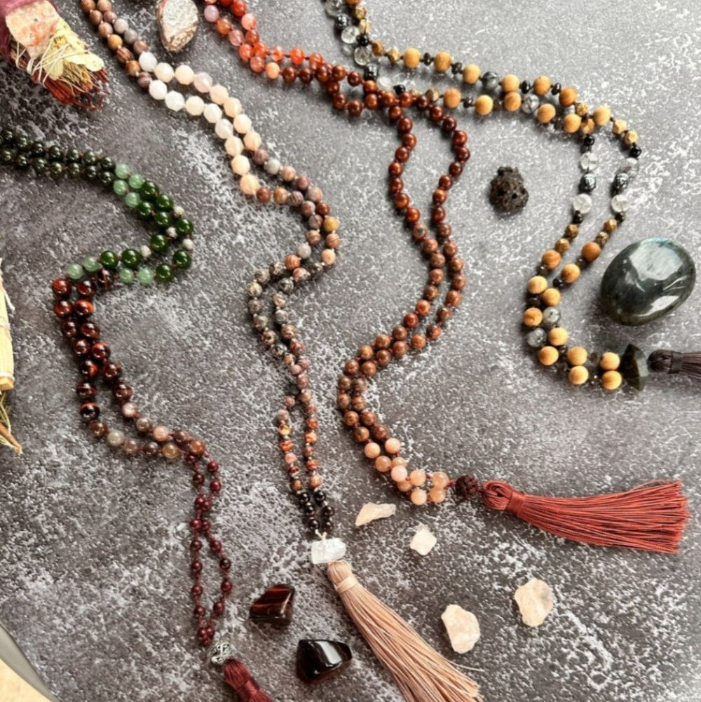 Beaded necklaces with tassels on a textured surface